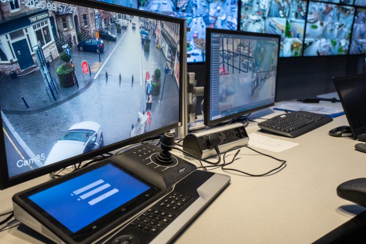 Bank of CCTV monitors.